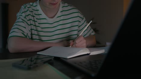 teenager studying late night