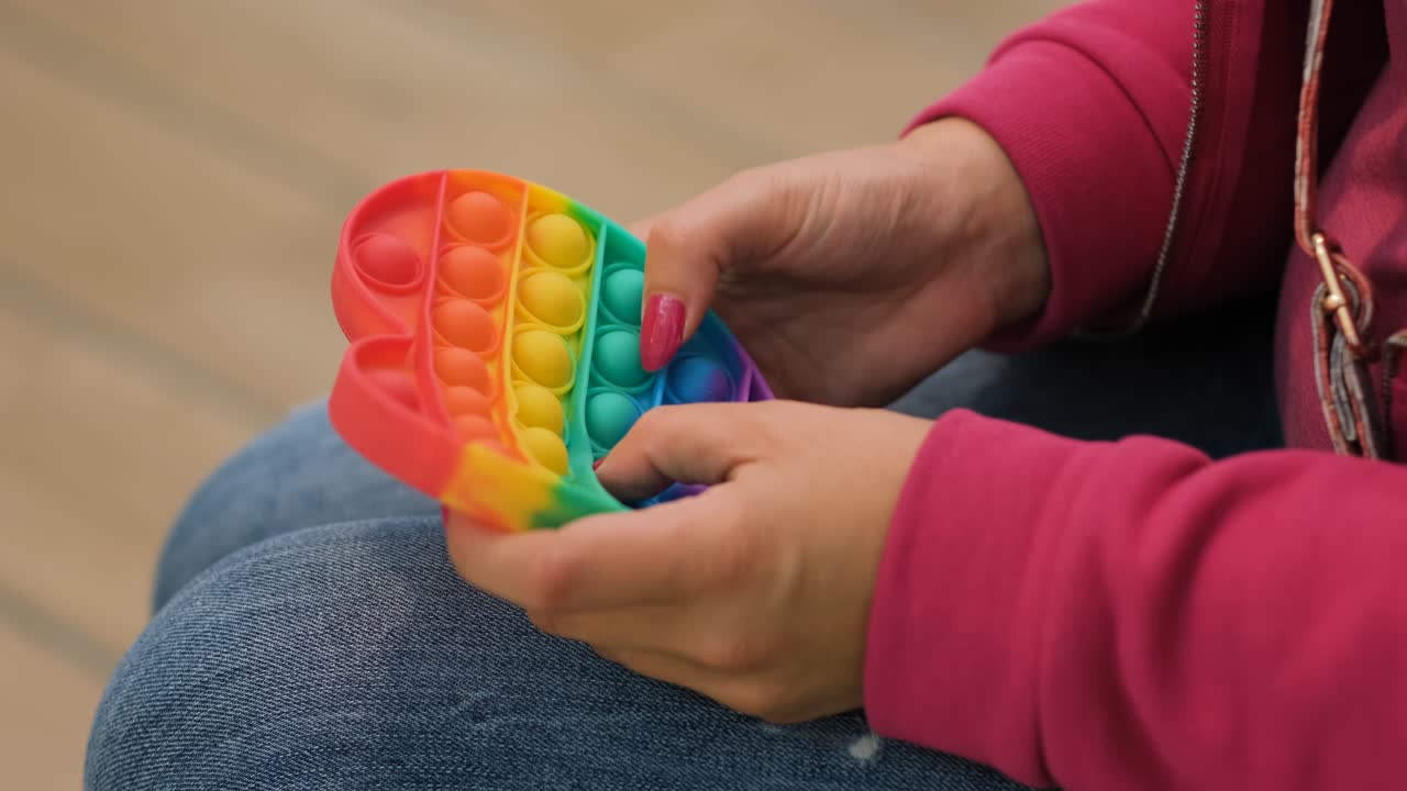 Close-up of Woman Playing with Pop it Toy Fidget