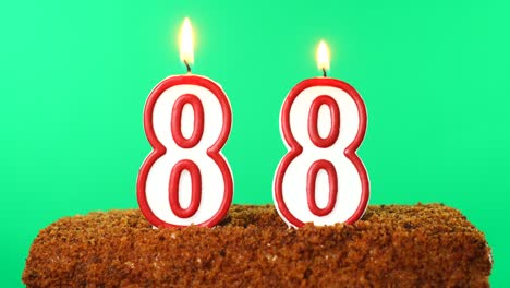 cake with the number 88 lighted candle. chroma key. green screen. isolated