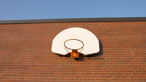 basketball hoop on a red brick wall