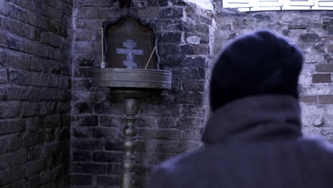 person in a wheelchair in a dark, old church