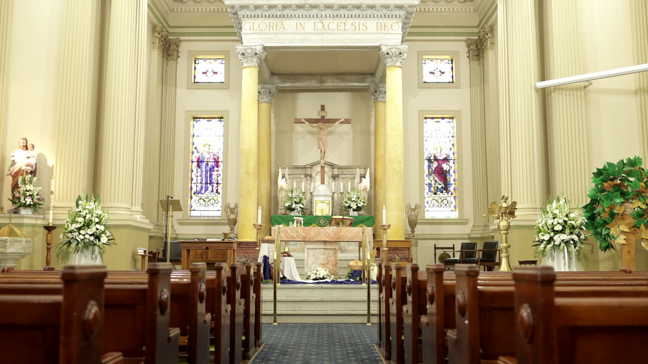 Chancel and altar of catholic church, forward shot through aisle