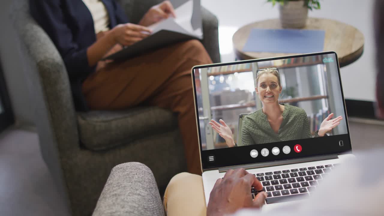African american man using laptop for video call, with business colleague on screen