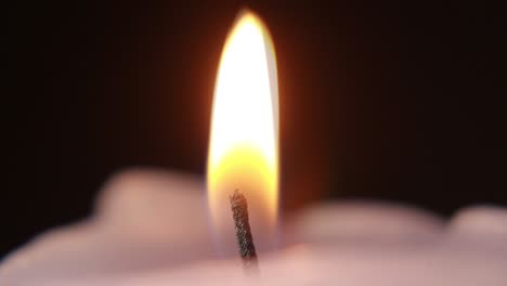 close-up of cutting candle wick with scissors