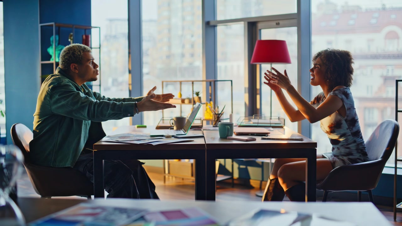 Man and woman arguing office desk. Business coworkers stressed work conflict.