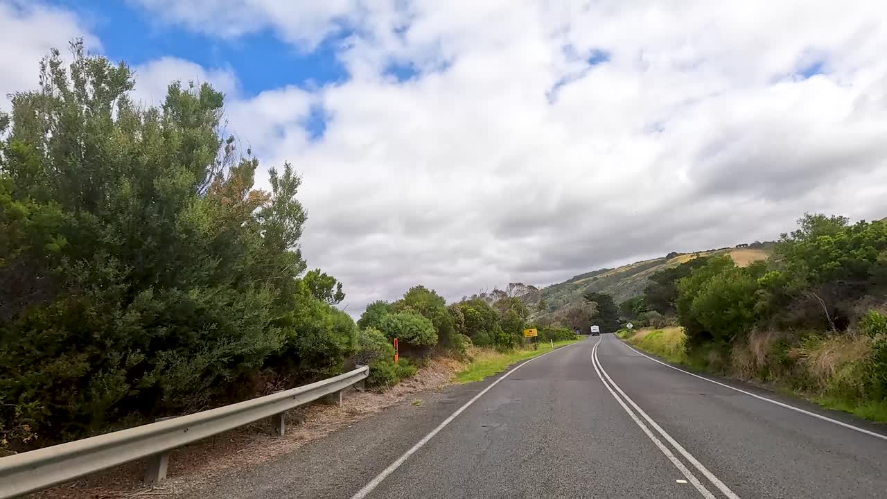 A 30-second journey showcasing lush landscapes and winding roads under a partly cloudy sky