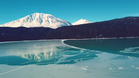 4K-Drone-Video-of-Snow-Covered-Lakeside-Mountains-in-Alaska-During-Winter