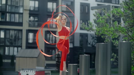 woman ribbon dancing outdoors