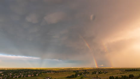 A-beautiful-rainbow-extends-down-from-a-thunderstorm-coming-off-the-mountains-in-Fort-Collins,-Colorado