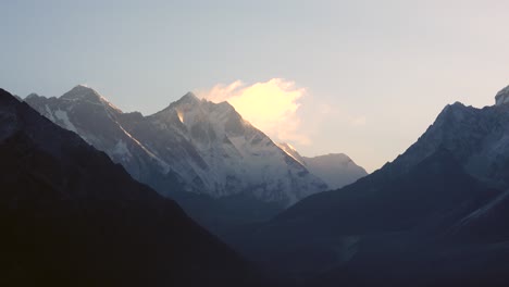 a view of the majestic himalaya mountains in the early morning light with a slight fog and haze in the foreground