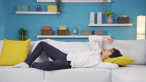man lying on the sofa is resting.