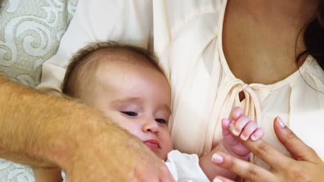 Baby-holding-the-finger-of-his-mother