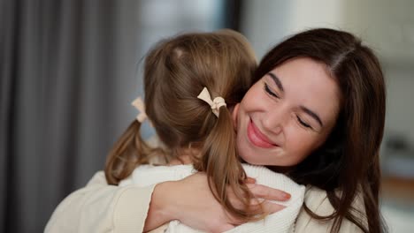 lovely mother hugging little daughter, adorable small child daughter embrace mum