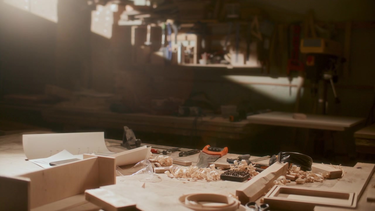 Interior of Sunlit Woodworking Workshop with Tools on Workbench
