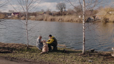 couple and dog by the lake