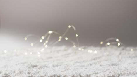 video of fairy lights christmas decorations with copy space on snow background