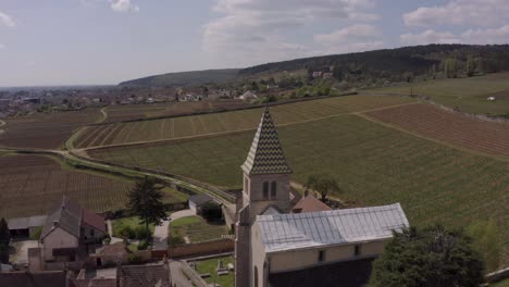 drone flyover historic fixin church, reveal scenery of famous vineyards, burgundy