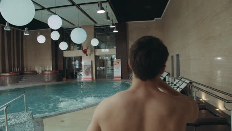 Handsome-man-entering-hotel-spa