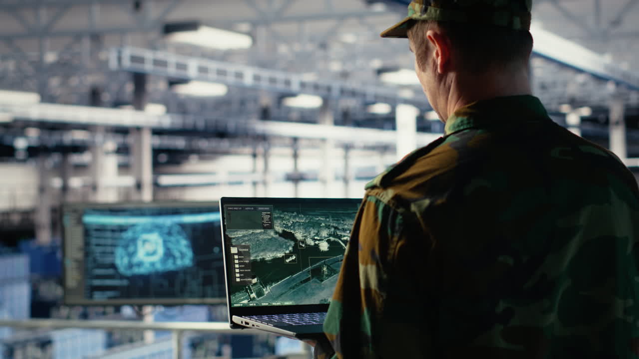 Military Engineer In Data Center Tracking Satellite Coordinates Using Laptop