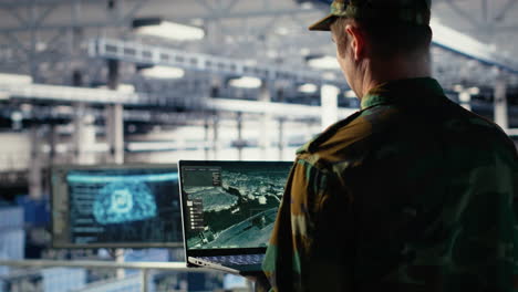 military engineer in data center tracking satellite coordinates using laptop