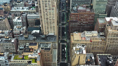 drone overview of traffic on a quiet street in cloudy midtown, new york, usa
