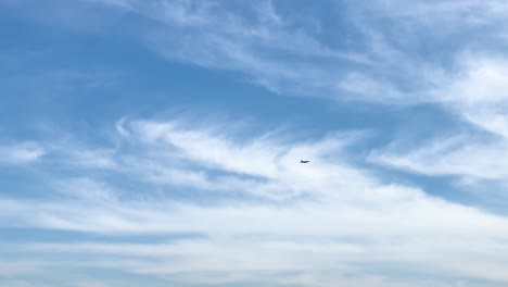 a super hornet jet flies across a clear blue sky in geelong, showcasing dynamic aerial movement and wispy cloud formations