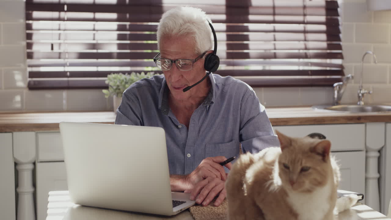 Senior Man on Video Call at Home with Cat