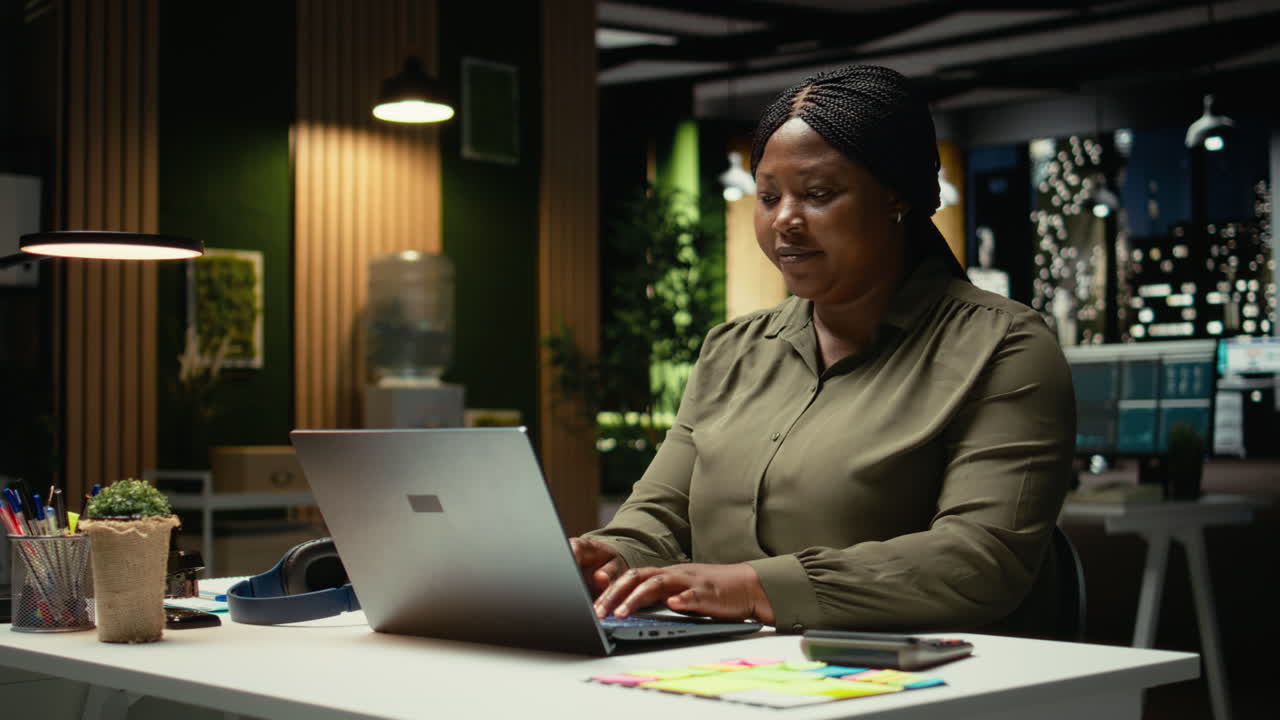 Female business consultant typing data reports and fact checking on laptop