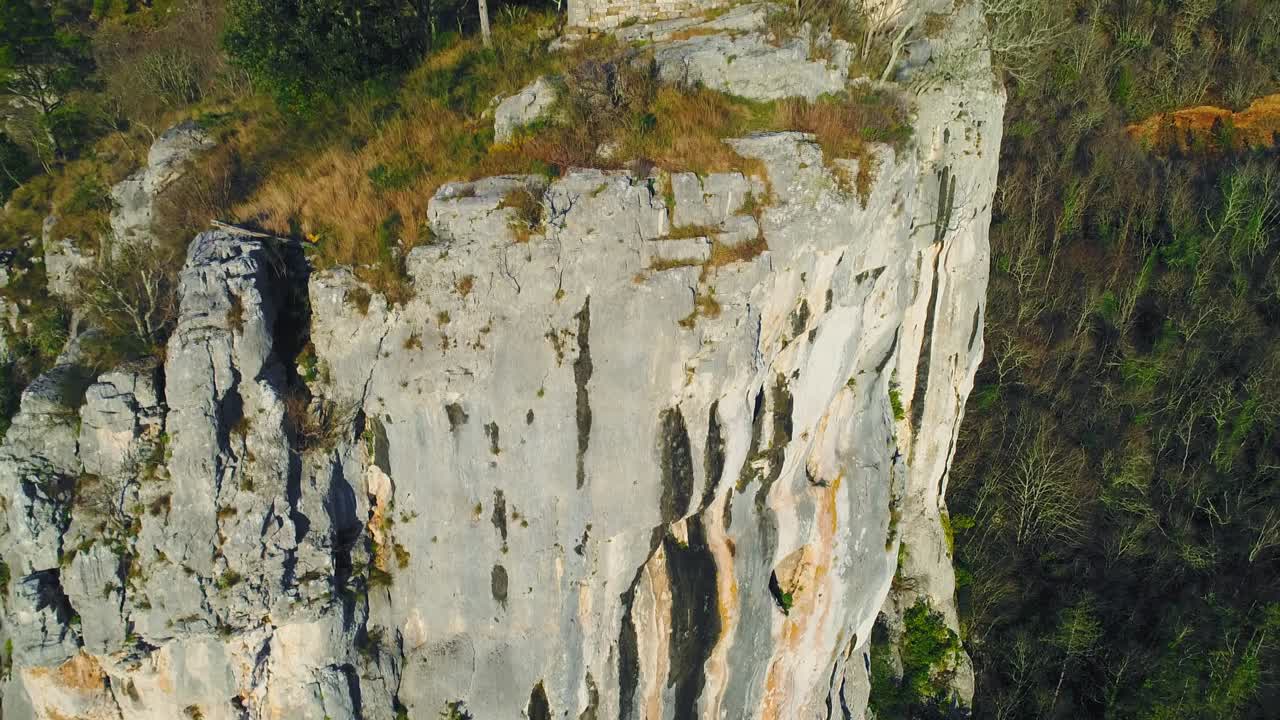 pedestal shot huge cliff rock wall, reveal abandoned church. Motovun, Croatia