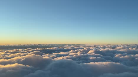 stunning view recorded from a jet cockpit while flying just over the clouds at sunset