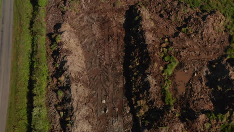 top down aerial shot over dug up piece of land