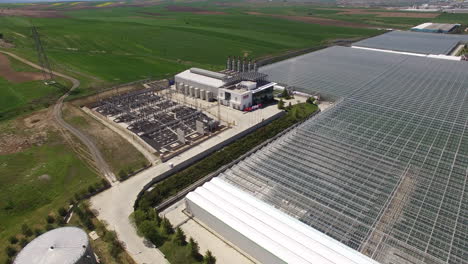 rotate and move away from the power plant, the moving away reveals a large greenhouse