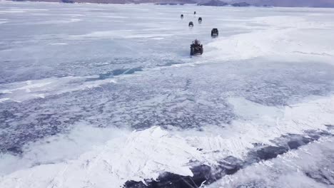 drone follow truck and cars winter daytime scene of crystal lake baikal