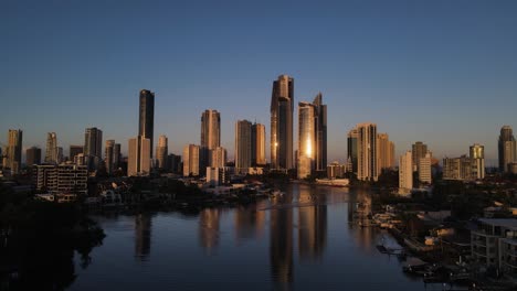 Aerial-view-of-the-Nerang-River-and-iconic-Surfers-Paradise-skyscrapers-glowing-in-the-afternoon-sunset-light