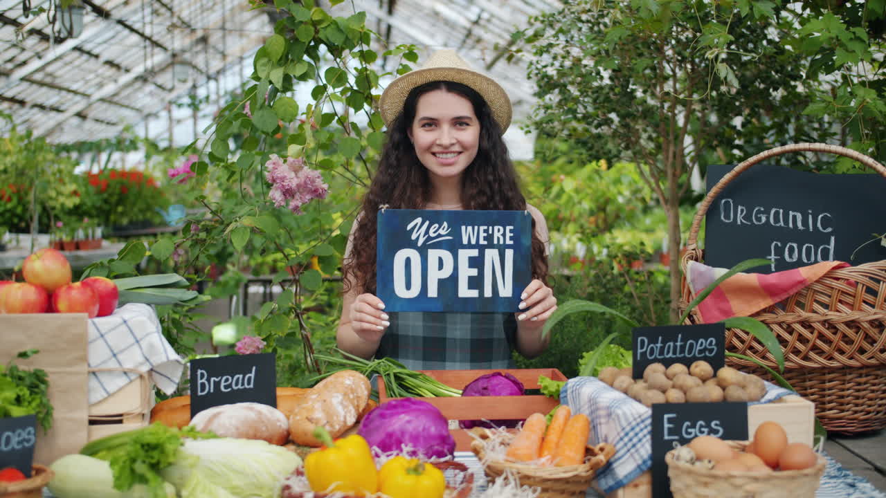 Smiling Woman Operating a Local Farm Market Stall