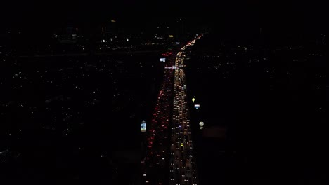 Toma-Aérea-Tráfico-Autopista-Vista-Nocturna-De-Una-Ciudad