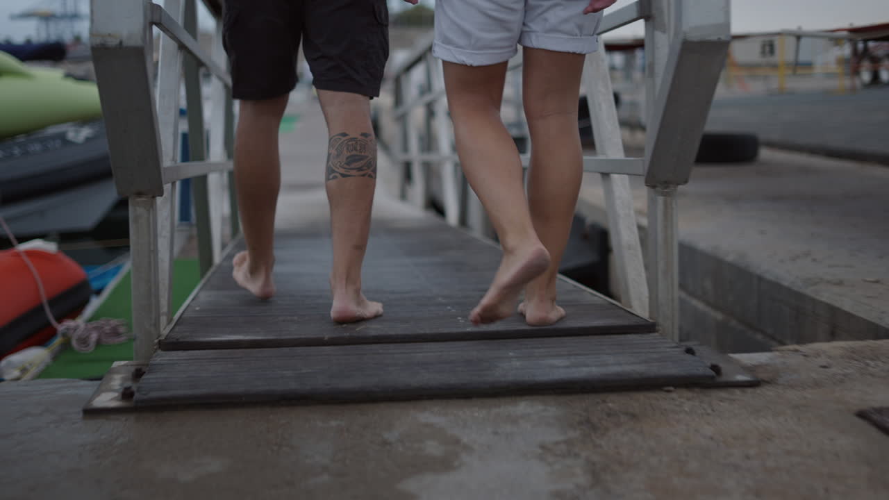 People walking barefoot on a concrete pier