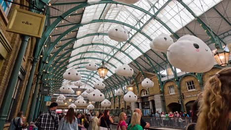 visitors admire whimsical cloud art installation