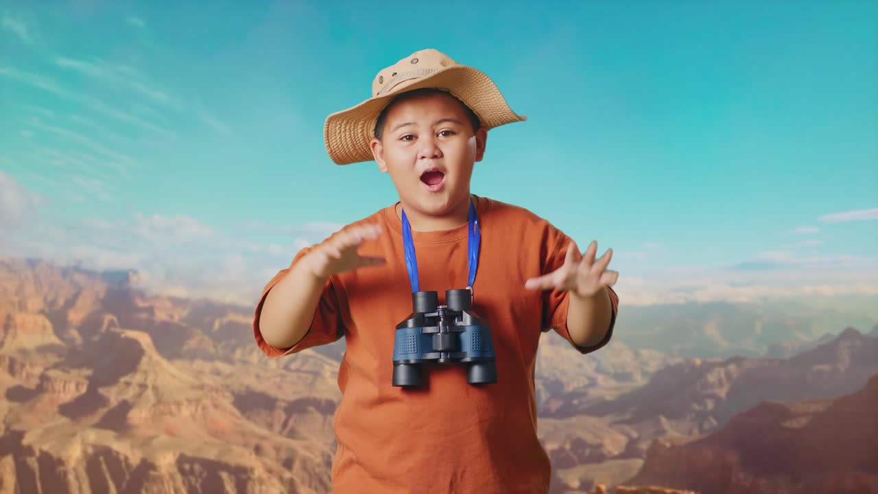Asian Boy With A Hat Saying Wow After Looking Through The Binoculars. Boy Researcher Examines Something While Traveling At The Top Of Mountain, Travel Tourism Adventure Concept