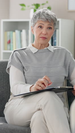 woman sitting in a chair, listening intently to a therapist