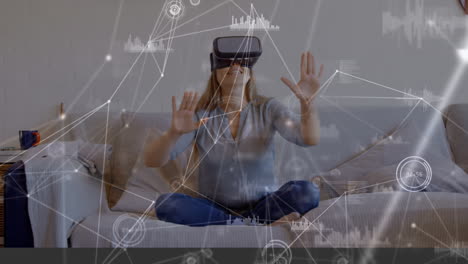 woman sitting on a couch wearing a virtual reality headset