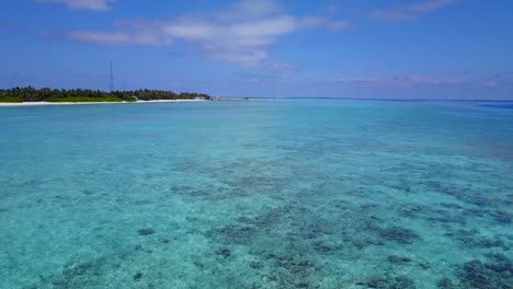 Amazing-aqua-clear-waters-and-reef-in-the-Maldives-with-Fulidhoo-Island-in-distance-4k