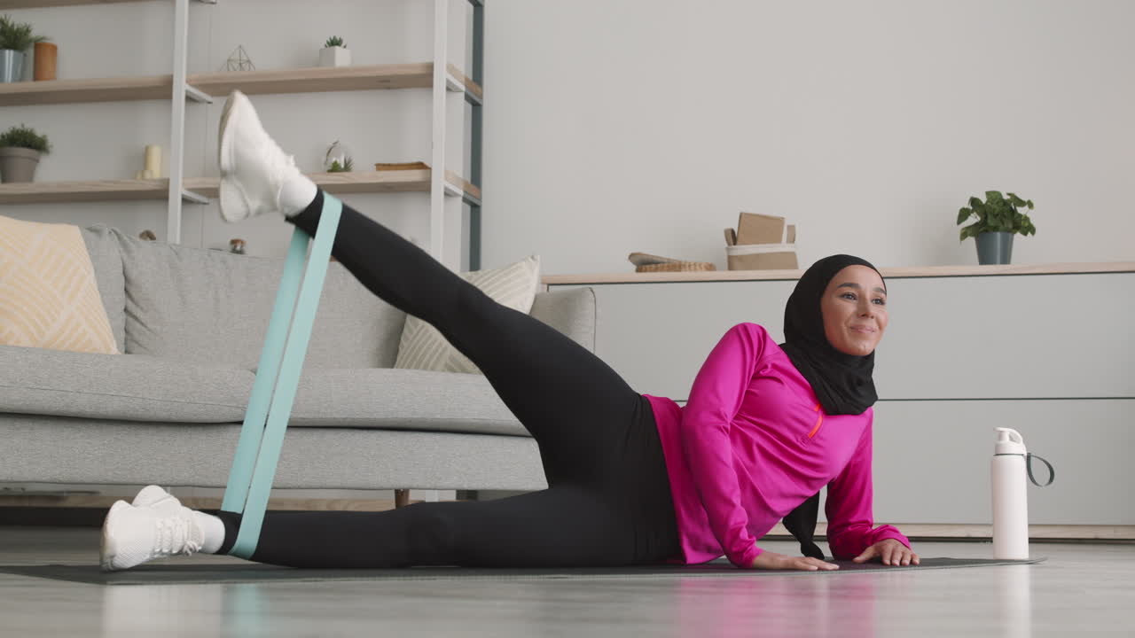 Woman exercising at home with resistance band