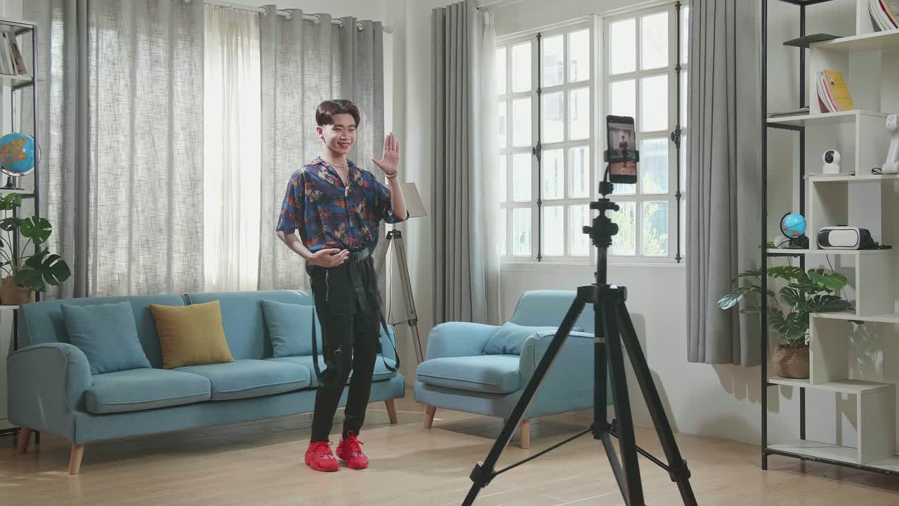 Man recording a social media video in his living room