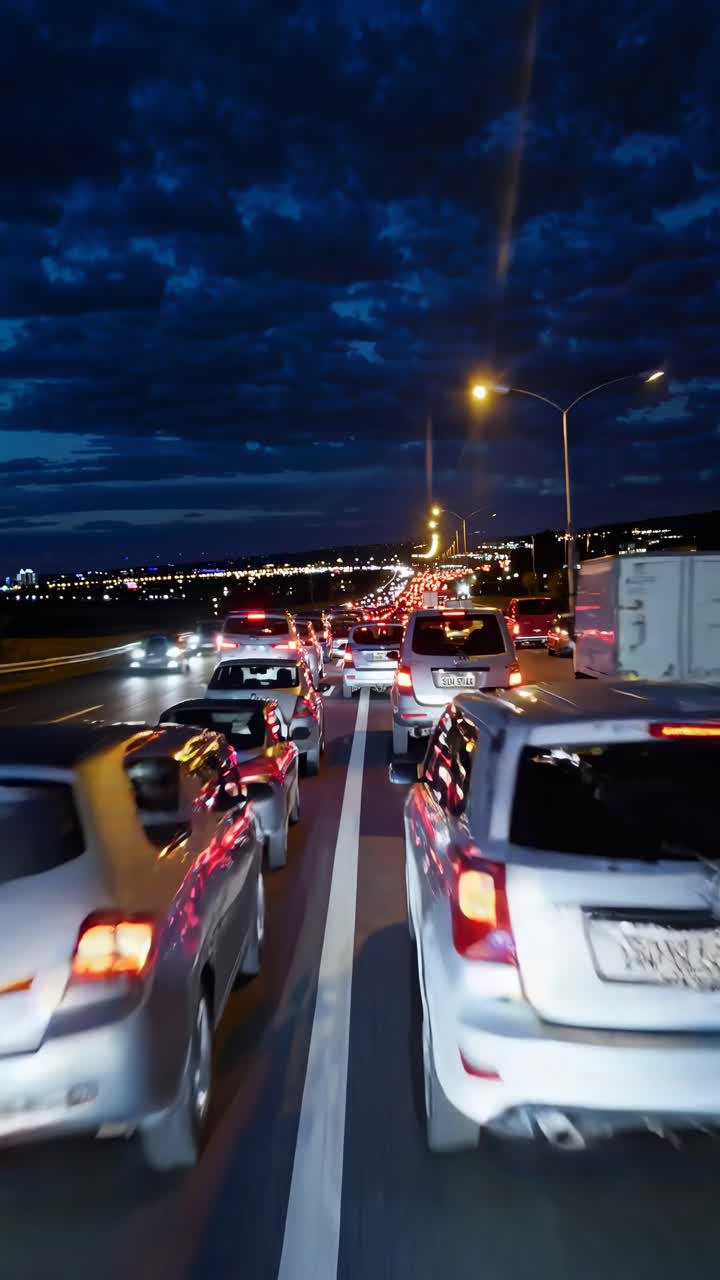A dynamic video still capturing a bustling highway at night from a rear-view angle, highlighting car