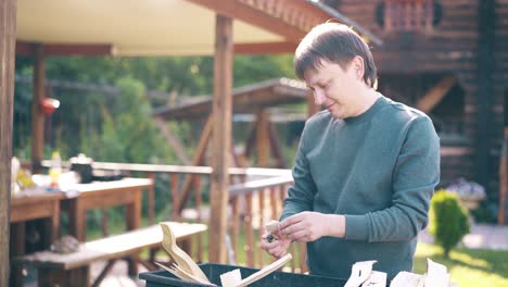 Travelling-Young-guy-is-standing-near-the-barbecue-in-which-coals-are-smoking-2