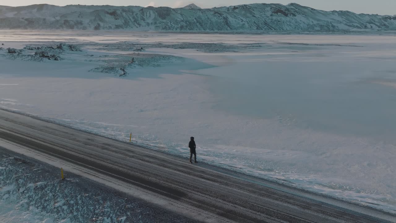Trekker on Lonely, Icy Road in Snowy Winter Iceland Landscape - Aerial