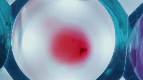 withdrawing blood with pipette from transparent liquid in test tube
