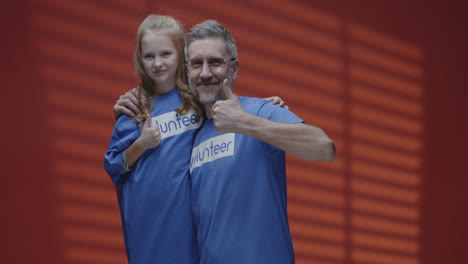 father and daughter volunteering together