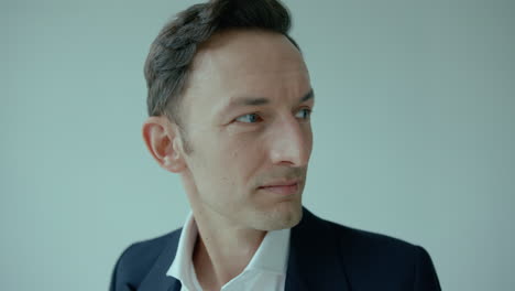 Portrait-Of-Stylish-Handsome-Man-adjusting-Collar-Of-His-Shirt-and-Looking-Aside-In-Confidence